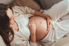 Schwangere berührt sanft ihren Bauch, um Beckenlage vorzubeugen