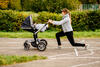 Mutter macht Ausfallschritt mit Kinderwagen
