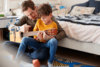 Vater und Sohn spielen Gitarre